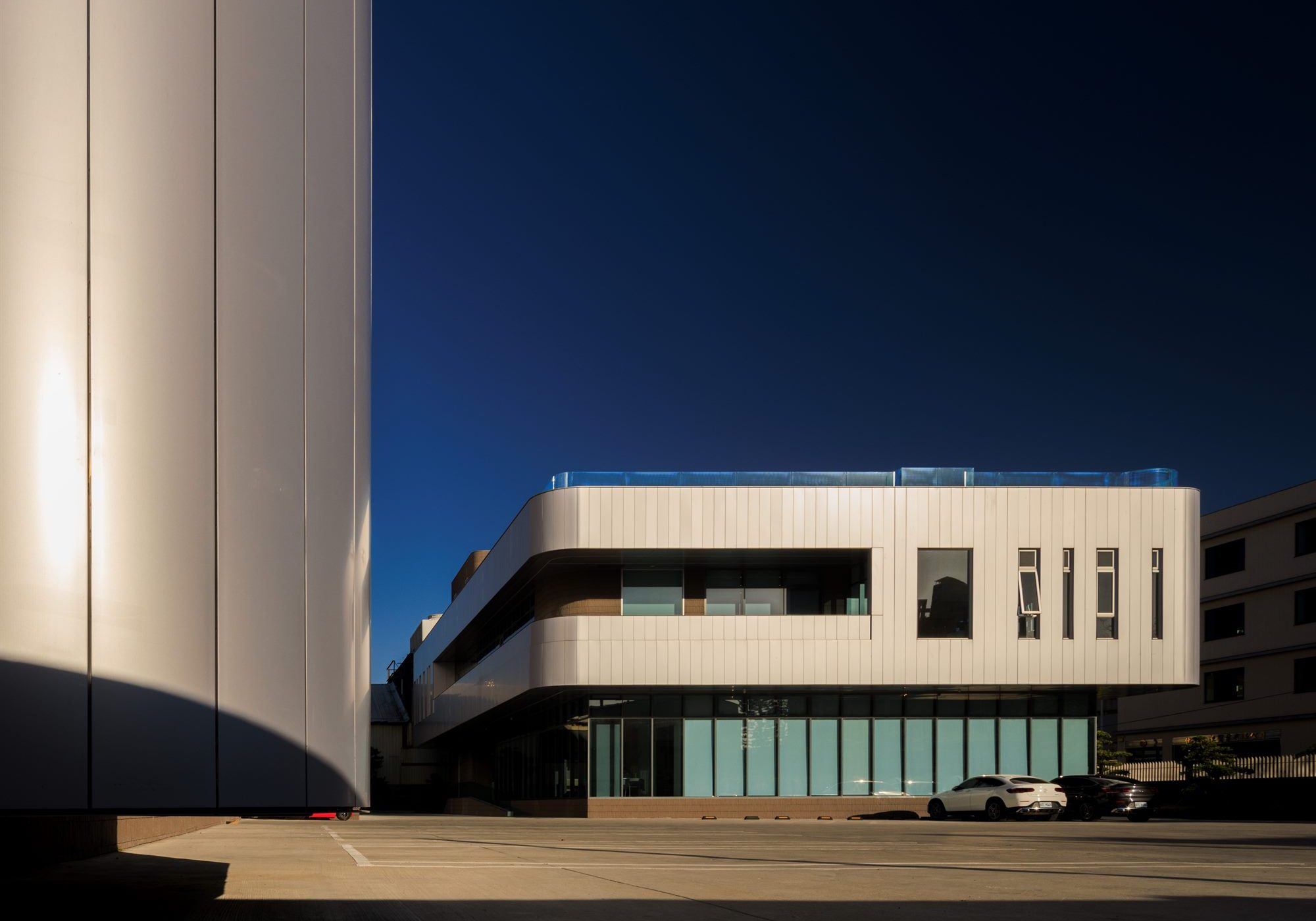 Quest Composite office building with metallic façade and dark glazing against a blue sky